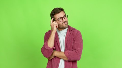 Handsome man with glasses having doubts over isolated background