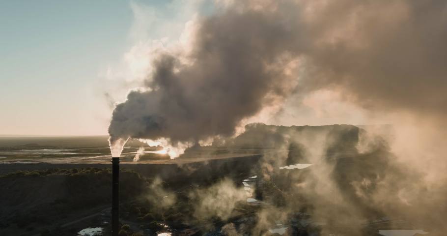 Climate change. Pollution. Global warming. Close-up aerial view of greenhouse gasses being emitted from a mine smoke stack | Shutterstock HD Video #1081655306