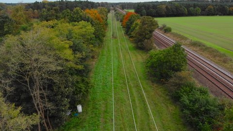 Aerial: Thetford forest with railway track and electric line at Brandon, England - drone flying shot