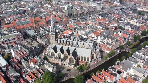 Aerial view of The Oude Kerk in English Old Church is Amsterdam’s oldest building and youngest art institutes it stands in De Wallen the main red-light district in Oudekerksplein 4k high resolution