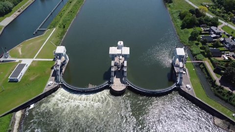High altitude aerial drone view of modern water channel controller controlled at both sides by a gate or lock these gates commonly control levels and flow rates in rivers and canals 4k footage 库存视频