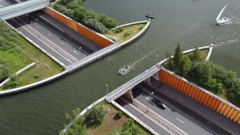 Aerial bird view of a road aquaduct or aqueduct is structure used to conduct water across two places in this case modern engineering to connect a lake over a highway like a water-bridge 4k quality