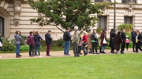 PARIS, FRANCE - OCT 30, 2021: Long queue line of people waiting to enter a Petit Palais art museum due to the pandemic limit on the number of visitors