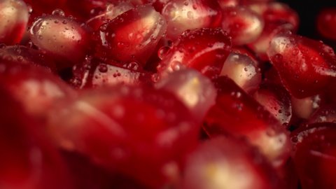 Lots of pomegranate tree berries seeds, close-up. Pomegranate for making juice. Healthy and vegetarian food. High quality. 4k footage.