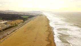 aerial over ocean wide beach line misty mountains hills and waves.san francisco
