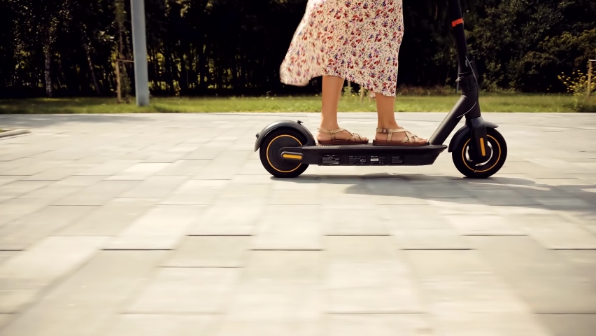 Fun Driving Electric Scooter. Relax On Kick Scooter. Sharing Ecology Transport. Woman Riding On Rent E-scooter. Urban Style Green Energy City Transport. Ecological Transportation Mobility In City Ride Royalty-Free Stock Footage #1081682744