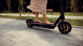 Eco Driving Electric Scooter. Relax On Kick Scooter. Sharing Ecology Transport. Woman Riding On Rent E-scooter. Urban Style Green Energy City Transport. Ecological Transportation Mobility In City Ride - Powered by Shutterstock - Get 15% off with code: PIKWIZARD15