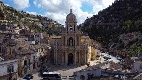 orbiting clockwise around church surrounded by cliffs in Scicli Sicily