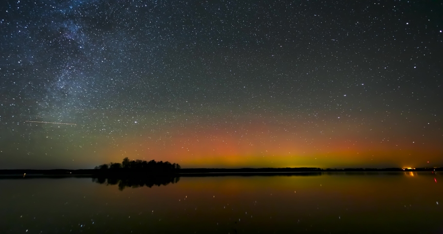 Timelapse with Milky way and Northern lights - Aurora borealis over the lake in Lithuania Royalty-Free Stock Footage #1081686257