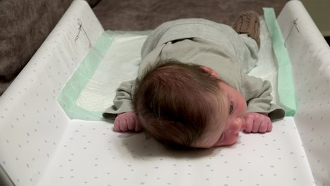 Newborn Baby Is lying on his stomach (Tummy time).