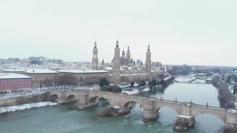 Aerial view in full hd of the city of Zaragoza snowed by the storm Filomena, an unusual image for this city in Spain
