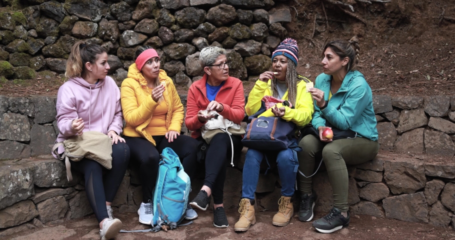 Multiracial women taking a break in the forest during hiking day