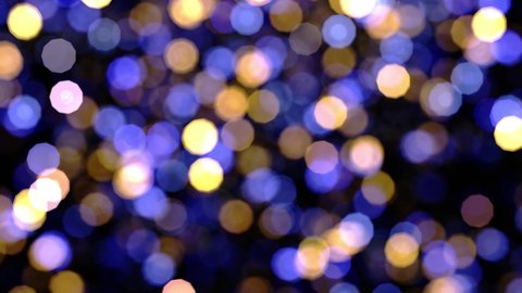 Realistic looping 3D animation of the blue and yellow shining light particles bokeh rendered in UHD as motion background
