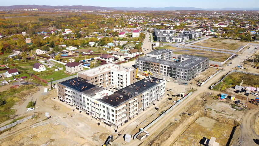 Construction of new residential buildings. Construction site. New microdistrict in the suburbs of Vladivostok. View from above. Royalty-Free Stock Footage #1081701050