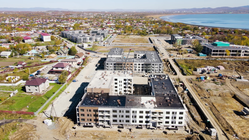 Panoramic shooting of the construction progress of new residential buildings. Construction of residential buildings. New microdistrict in the suburbs of Vladivostok. View from above. Royalty-Free Stock Footage #1081701086