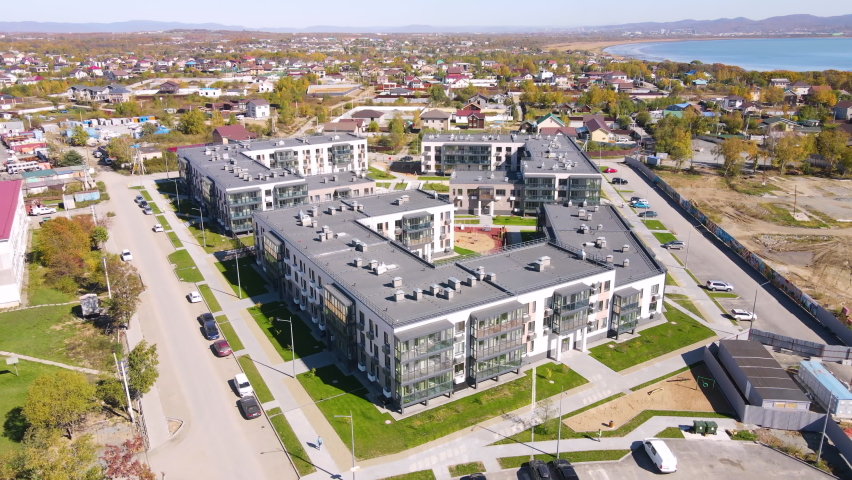 Panoramic shooting of a new residential neighborhood. New microdistrict in the suburbs of Vladivostok. View from above. Royalty-Free Stock Footage #1081701092