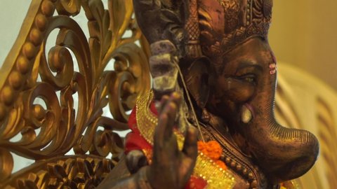 ganpati statue of Indian god dark stone closeup