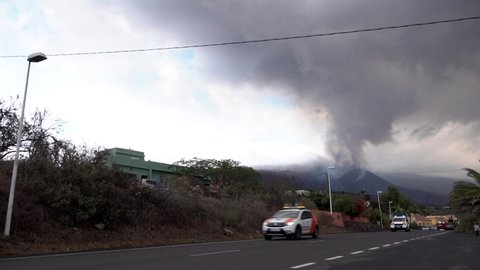 El Paso , Spain - 10 23 2021: Emergency vehicles and and cars drive away from the erupting Cumbre Vieja volcano