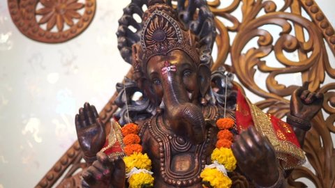 ganpati statue of Indian god dark stone slow motion