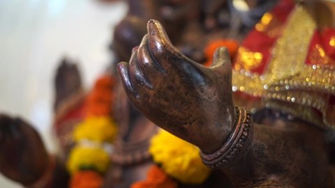 ganpati statue of Indian god dark stone closeup of hand