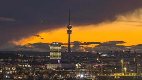 Munich skyline at night, munich tv tower night lighs at dusk time lapse video in 4k.