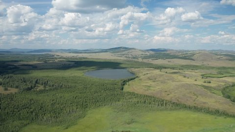 Scenic aerial view of landscape with Ural mountains, green forest and blue lake at Bashkortostan, South Ural, Russia