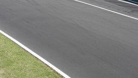 Motor sport concept, unrecognizable race cars fast on asphalt track rear view clip with original sound