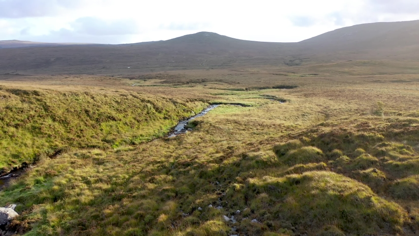 Beatiful stream flowing from the Mountains surrounding Glenveagh National Park - County Donegal, Ireland. Royalty-Free Stock Footage #1081721834