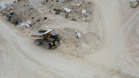 ALICANTE, SPAIN – SEPTEMBER 10, 2021. Aerial view of heavy machinery working in a marble quarry in Pinoso, Alicante, Spain.