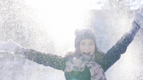 Happy young lady throwing up the snow up. Winter, sport, holidays, relationship, love, xmas, lifestyle concept. Filmed on cinema camera, 10 bit color space.