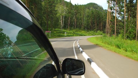 POV: Car is moving on curving road in Altay, Russia