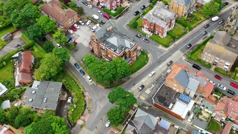 Aerial drone footage of the town centre of Scarborough in the UK, showing the British residential housing estates and historical town houses along side the main roads in the seaside town