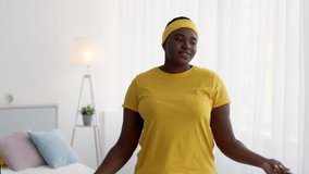 Training Fun. Cheerful Black Overweight Woman In Sportswear Fooling While Exercising With Jump Rope At Home, Funny Plus Size Lady Dancing With Skipping Rope Enjoying Domestic Workouts, Slow Motion