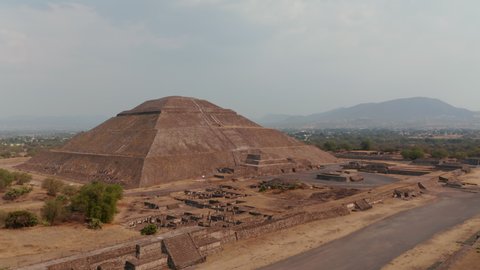 Slide and pan footage of Pyramid of the sun. Large ancient stone structure.Ancient site with architecturally significant Mesoamerican pyramids, Teotihuacan, Mexico