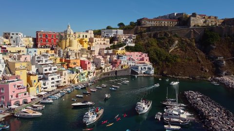 Aerial drone footage of the Procida typyical old town with its fisherman harbor in the bay of Napoli in Italy. Shot with a rotation motion. 