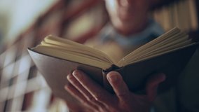 Senior man reading a book in public library, turning pages, doing research - Powered by Shutterstock - Get 15% off with code: PIKWIZARD15