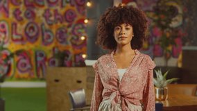 Portrait of smiling female server or owner standing in cool bar or club - shot in slow motion - Powered by Shutterstock - Get 15% off with code: PIKWIZARD15