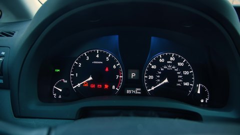 Many different car dashboard lights with warning lamps illuminated