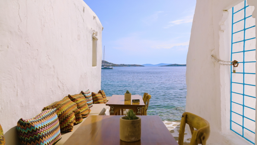 Reserved table in an outdoor romantic restaurant near the Mediterranean Sea in Mykonos, Greece | Shutterstock HD Video #1081742534