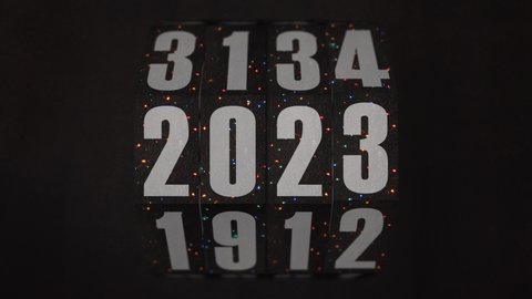 Vintage Christmas rotating counter blinking lights switches from 2021 to 2026 on dark textured background