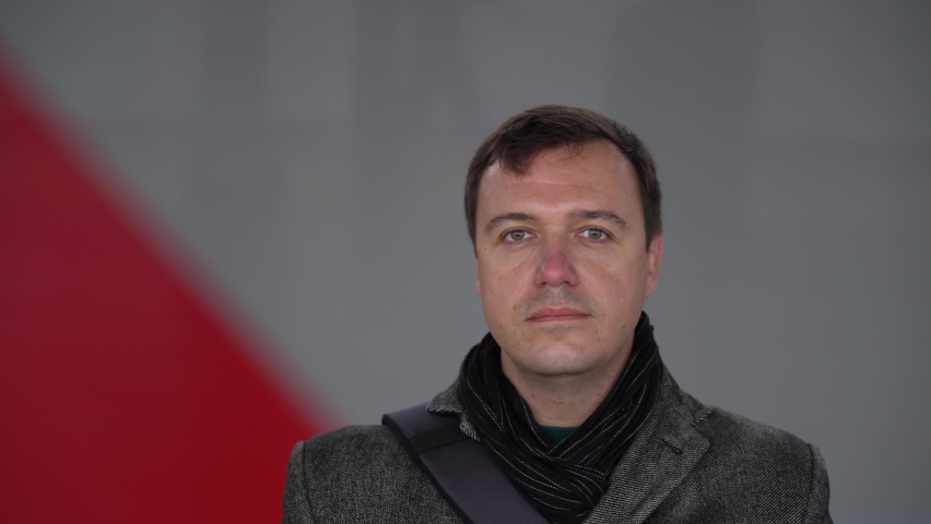 Millenial business man in formal wear. Close up portrait on mooving train on background