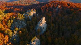 Drone flies over epic limestone rocks on a sunny day. Location Dovbush Rocks, Carpathian mountains, Ukraine, Europe. Cinematic aerial shot. Discover the beauty of earth. Filmed in 4k, drone video.