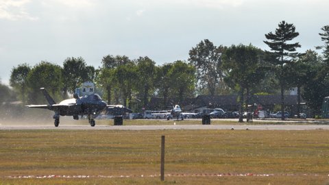 Rivolto, Italy - SEPTEMBER, 17, 2021: Front tracking view military aircraft take-off from runway on sunny day in air base for air show display. Lockheed Martin F-35B Lightning II of Italian Air Force 