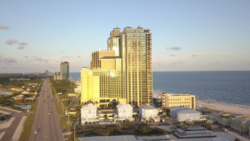 Skyscrapers And National Highway at The Shore Of Orange Beach In Alabama, USA. aerial, forward