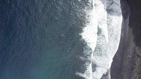 Top View Of Foamy Waves Running Ashore At Playa de Nogales In La Palma, Canary Islands, Spain With Black Volcanic Sand. aerial