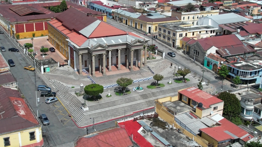 Teatro Municipal de Quetzaltenango. Drone footage of Municipal Theater of Quetzaltenango in urban colonial Central American city of Xela, Guatemala. Camera tracking right, panning left. Daylight. Royalty-Free Stock Footage #1081764023