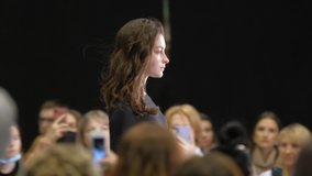 Beautiful female model walking down runway podium. Women on fashionable expo week. Haute couture catwalk, elegant people vogue. Beauty girl catwalks on fashion show stage, delicate person defile look. - Powered by Shutterstock - Get 15% off with code: PIKWIZARD15