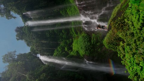 Buleleng Regency, Bali - Indonesia - June 2 2021: Travel people explore one of the hidden gems of the North island Bali Sekumpul Waterfall Bali, Indonesia. 4K Aerial UHD Video Clip