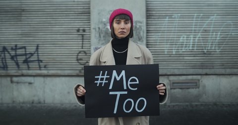 Lviv, Ukraine - November 27, 2019: Hipster girl with Me too sign in hands. Young woman supporting movement against sexual misconduct and violence. Concept of social problems.