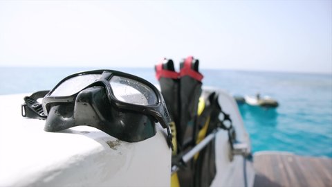 Snorkeling set on boat, sea, island.
